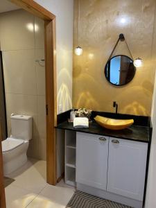 a bathroom with a sink and a mirror at Lofts Urbano in Urubici