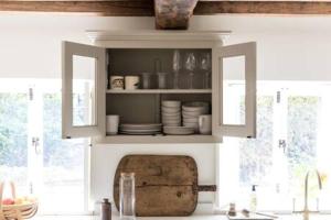 a kitchen with a sink and a cabinet with dishes at Two Rose Walk Cottage Cotswolds in Moreton in Marsh