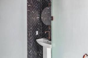 a bathroom with a sink and a mirror at Red Room at the Grand Maloney in Key West +18 photos