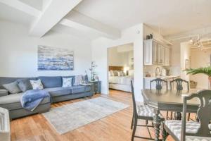 a living room with a couch and a table at The Executive Loft - Walk to Sanford Stadium in Athens