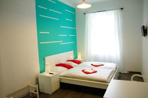 a bedroom with a bed with red pillows on it at Budget Apartment in Prague