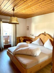 a bedroom with two beds and a large window at Apartment Gertrud in Castelrotto