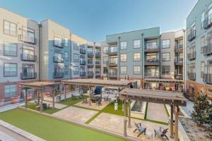 an apartment complex with a courtyard with tables and benches at A VIBE in DEEP ELLUM! in Dallas