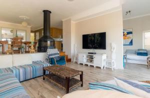 a living room with a couch and a tv at The Sea Soul in Cape Town