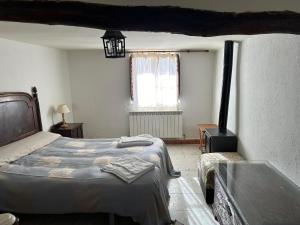 Postel nebo postele na pokoji v ubytování Casa Rural El Reloj