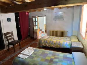 Postel nebo postele na pokoji v ubytování Casa Rural El Reloj