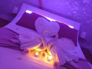 a bed with a stuffed animal and lights on it at Heaven Loft in Yvetot