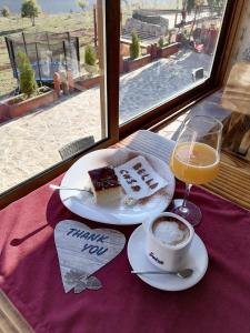 a table with two plates of food and a cup of coffee at S.R.C BELLA CASA in Crvena Voda