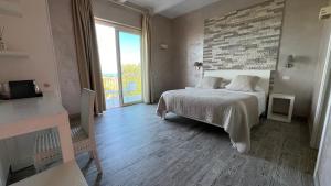 a bedroom with a bed and a brick wall at Borgo di Santa Barbara in Santa Domenica