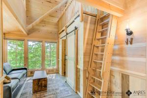 a log home with a spiral staircase in a living room at The Green Ash in Treehouse Grove at Norton Creek in Gatlinburg +28 photos