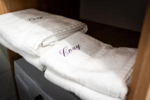 two white towels with the word love written on them at Cozy Luxury Apartments Maurer Residence #Targu Mures in Târgu-Mureş