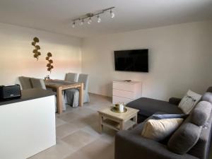 a living room with a couch and a table at Apartment am Pulverturm in Quedlinburg