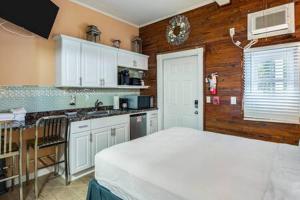 a kitchen with a white bed in a room at Coral Cove #1 by Brightwild in Key West