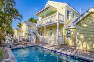 a house with a swimming pool in front of a house at Coral Cove #1 by Brightwild in Key West