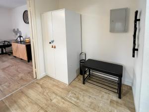 a room with a door and a bench and a table at Au cœur des Arènes - Parking privé in Metz