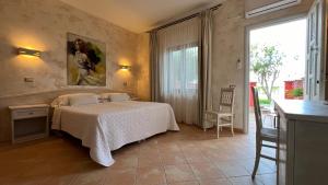 a bedroom with a bed and a large window at Borgo di Santa Barbara in Santa Domenica