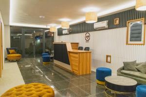 a lobby with a reception desk and a couch andools at Chak’z 1964 Beach in Dharavandhoo