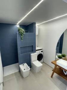 a bathroom with a toilet and a washing machine at Casa Del Mar in Costa de Antigua +8 photos