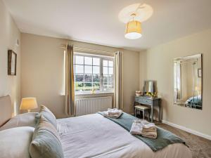 a bedroom with a large bed and a window at 3 Bed in Cockermouth 90920 in Tallentire
