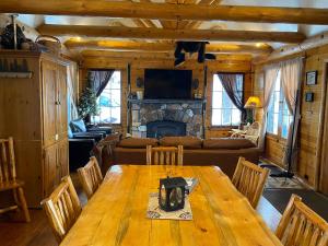 a living room with a wooden table and a fireplace at Tahoma Meadows - Sugar Pine Cabin in Tahoma