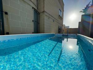 a large swimming pool with blue water in a building at BaySide1 Marsaxlokk Malta in Marsaxlokk