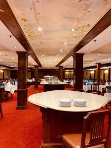 a dining room with a table with plates on it at Prince Omar Nile Cruise - Luxor to Aswan in Aswan