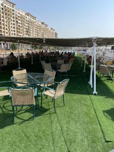 a glass table and chairs on the grass with a tent at Prince Omar Nile Cruise - Luxor to Aswan in Aswan