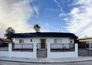 a white house with a palm tree on top of it at Very cute and comfy Apartment in Las Vegas