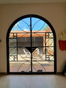an arched window with a view of a patio at Casa Sandy in Cozumel