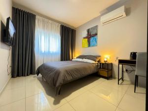 A bed or beds in a room at BaySide1 Marsaxlokk Malta