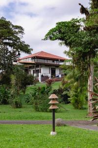 a house with a bird bath in the grass at Villa Blanca Cloud Forest Hotel & Retreat in San Ramón