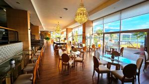 a restaurant with tables and chairs and a chandelier at Hotel Potrero De Los Funes in Potrero de los Funes