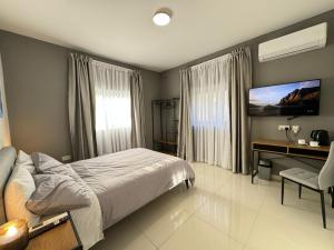A bed or beds in a room at BaySide1 Marsaxlokk Malta