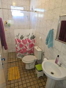 a bathroom with a toilet and a sink at Casa para temporada in Vera Cruz de Itaparica