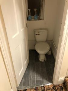 a small bathroom with a toilet and a door at 275 in Nottingham