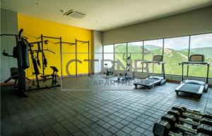 a gym with a yellow wall and some tread machines at Ambar Roca Santa Marta By CTBNB in Santa Marta