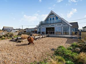 a house on the beach with a large building at 3 Bed in Whitstable 91641 in Seasalter