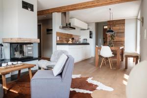 a living room with a couch and a table at Suite Franz Tegernsee in Tegernsee