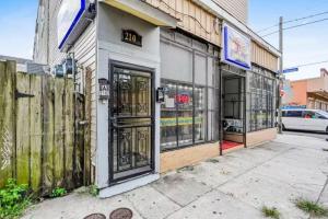 an empty building with doors and windows on a street at Penthouse on Claiborne in New Orleans