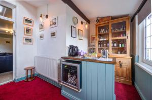 a kitchen with a counter and a bar in a room at Edale House B&B in Parkend