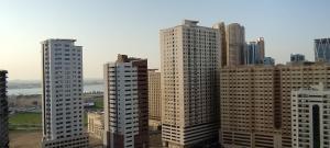a group of tall buildings in a city at housesuits7 in Sharjah