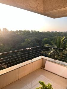 a balcony with a view of the forest at 2BHK Fully Furnished Penthouse With Living Hall And Kitchen Krishi Nagar Nashik in Nashik
