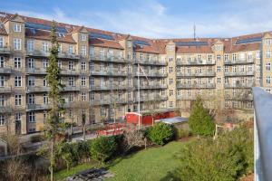 un gran edificio de apartamentos con muchas ventanas en Hyggelig & Lys Lejlighed med plads til 4 nær Zoo en Copenhague