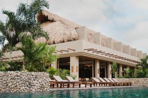 a resort with lounge chairs and a swimming pool at Naio in Palomino