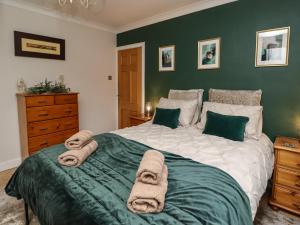 a bedroom with a large bed with towels on it at Base Camp in South Shields