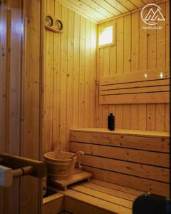 a bathroom with a tub in a wooden cabin at Vila Marija HP in Han Pijesak