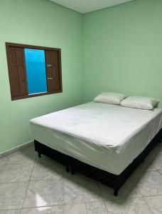 Postel nebo postele na pokoji v ubytování Casa Praia Los Remos Guarapari-Enseada + 29 fotografií