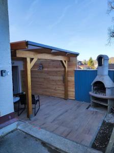 a patio with a woodburning stove and a building at Suite 13 Loft mit Terrasse in Teublitz