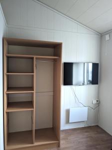 um quarto com uma estante de livros e uma televisão em Haugesund Urban Hotel em Haugesund