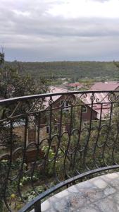 a iron fence with a bench on a balcony at GUEST House in Qusar